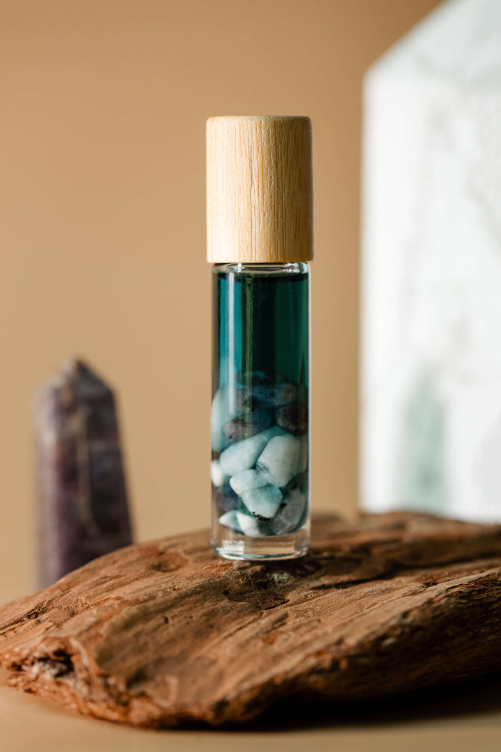 Small glass bottle with a wooden cap on a wooden surface
